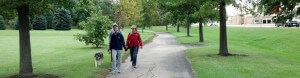 Walkers and a dog along a trail